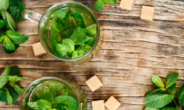 istock Cup of mint tea on wooden background, top view, copy space 1141691894