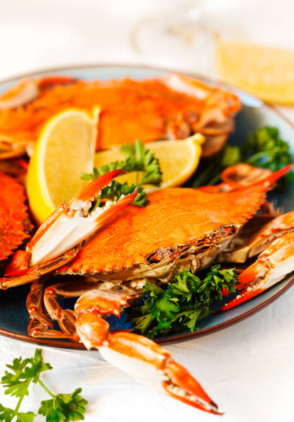 istock Cooked crabs served on plate with lemon and parsley. 1141691927