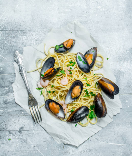 istock Mediterranean pasta. Spaghetti seafood with clams on paper. 1141692028