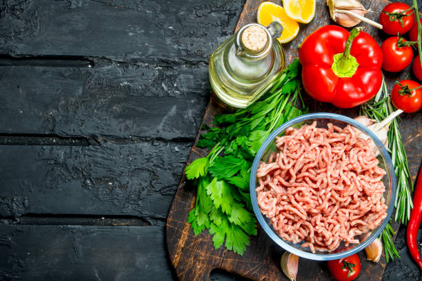 istock Raw minced meat in a bowl with vegetables and herbs. 1141692276