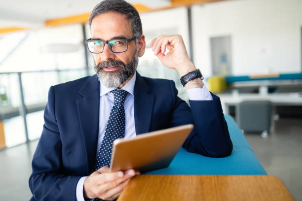 istock Confident senior businessman leader working in office 1141692408