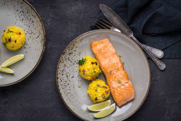 istock Grilled Salmon Fillet with Saffron Risotto on Dark Background 1141692490