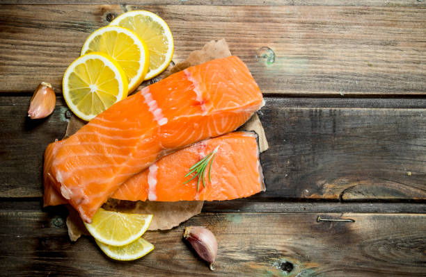 istock Raw salmon steaks with lemon wedges. 1141692541