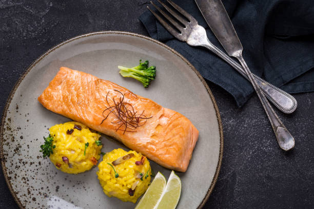 istock Grilled Salmon Fillet with Saffron Risotto on Dark Background 1141692618