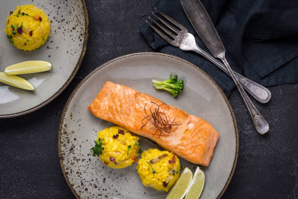 istock Grilled Salmon Fillet with Saffron Risotto on Dark Background 1141692793