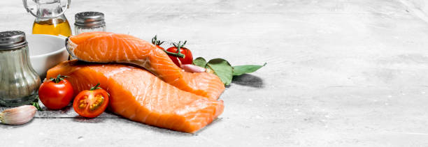 istock Raw salmon steaks with spices, herbs and olive oil. 1141692893