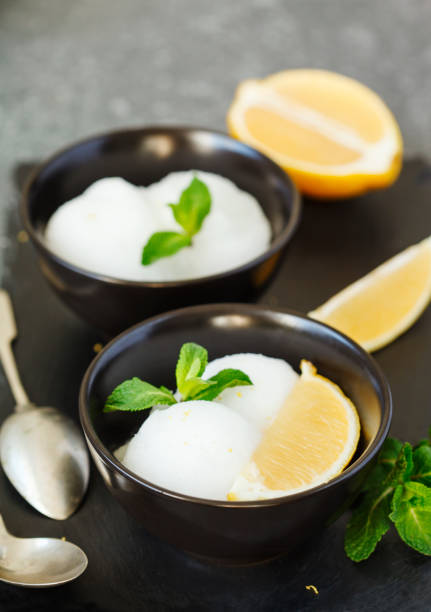 istock Lemon ice cream in black bowl. 1141693069