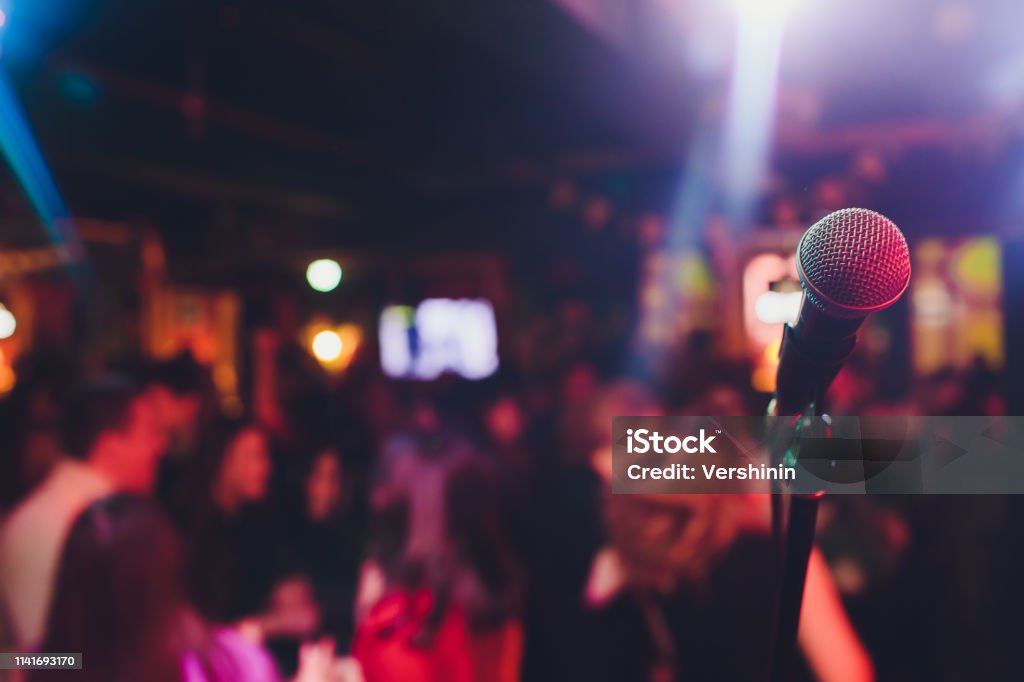 microphone against blur on beverage in pub and restaurant background. microphone against blur on beverage in pub and restaurant background Karaoke Stock Photo