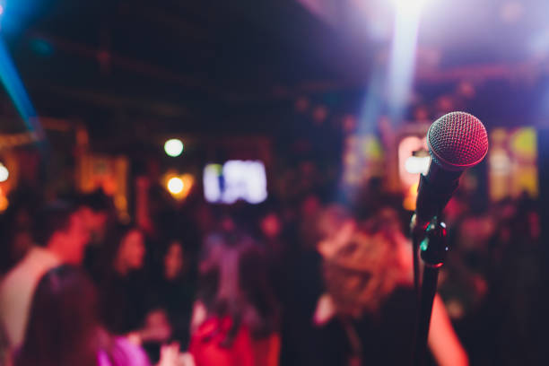 microphone against blur on beverage in pub and restaurant background. microphone against blur on beverage in pub and restaurant background karaoke photos stock pictures, royalty-free photos & images