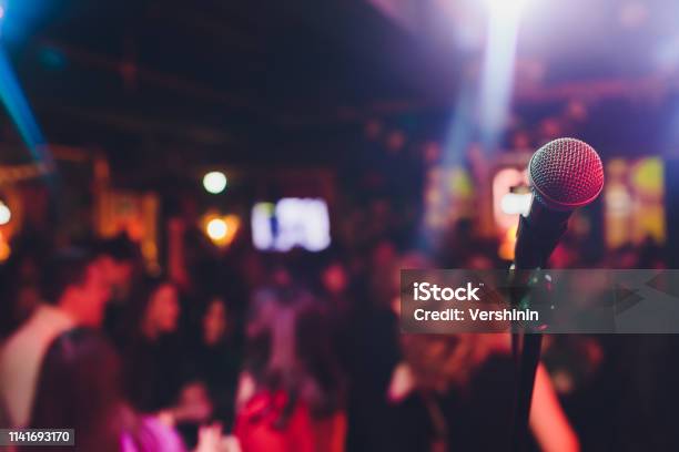 Microphone Against Blur On Beverage In Pub And Restaurant Background Stock Photo - Download Image Now