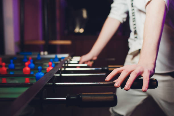 istock People Playing Enjoying Foosball Table Soccer Game Recreation Leisure. 1141693782