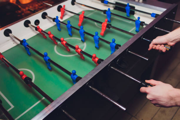 istock People Playing Enjoying Foosball Table Soccer Game Recreation Leisure. 1141693796