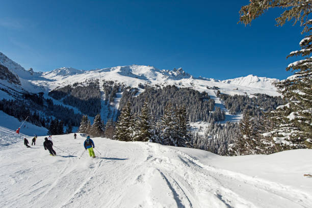 skieurs sur une piste dans la station de ski alpin - val thorens white snow winter photos et images de collection