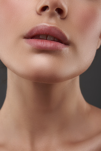 Close up of attractive lady with perfect skin keeping mouth slightly open