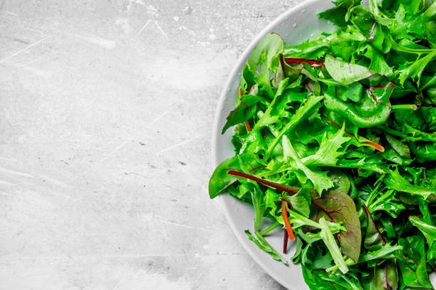 istock Healthy salad. Arugula salad in a bowl. 1141695647