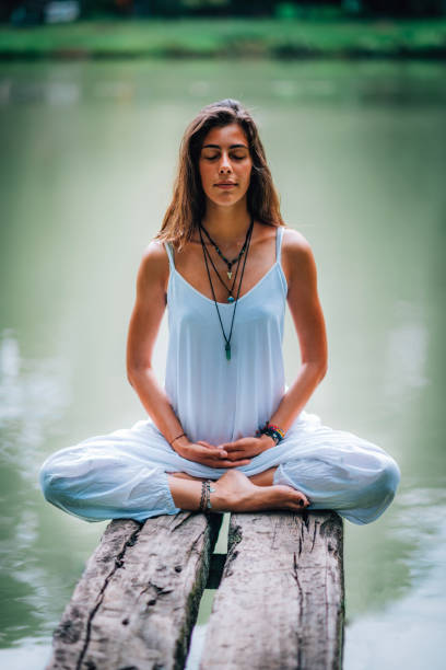 istock Mindfulness. Woman Meditates by the Water. 1141695652