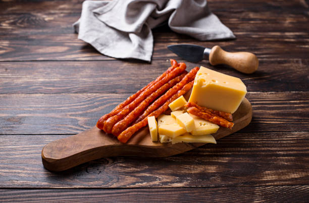 Cheese and salami sausage on wooden board. Antipasto or appetizer