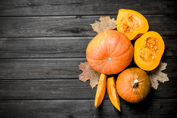 istock Pieces of fragrant pumpkin with leaves. 1141696590