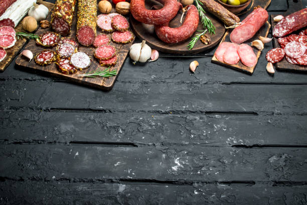 istock Different types of salami on wooden Board. 1141697602