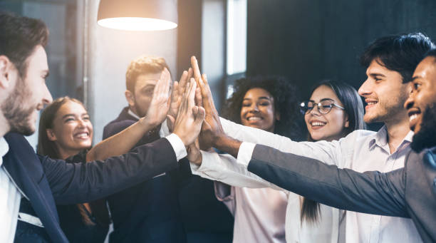 istock Happy office workers giving high five at meeting 1141697941