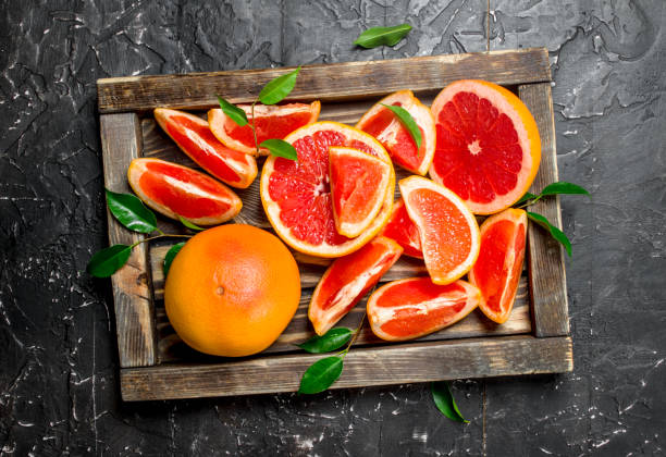 istock Ripe grapefruit on a wooden tray. 1141698040