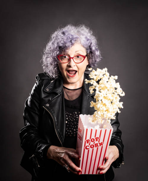istock older woman holding popcorn 1141698297