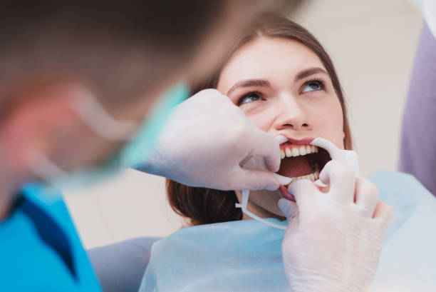 istock doctor orthodontist performs a procedure for cleaning teeth 1141698374