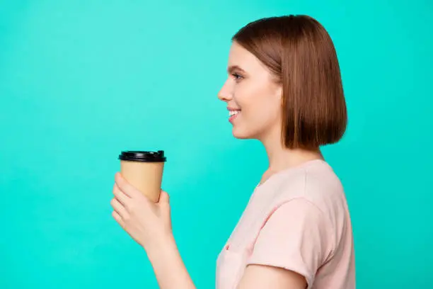 Close up side profile photo beautiful her she lady cute hold arm paper hot beverage best way wakeup awaking favorite americano latte boyfriend wear casual t-shirt isolated teal turquoise background.