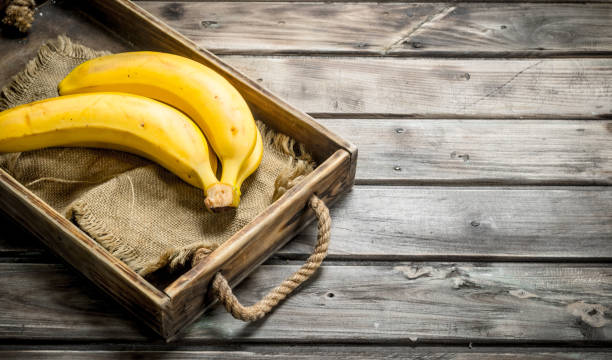 Fresh bananas on the bag in the old dressing.