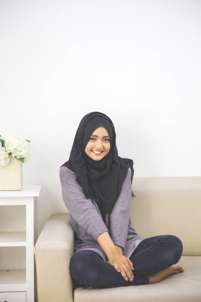 istock Muslim woman smiling and sitting 1141700485