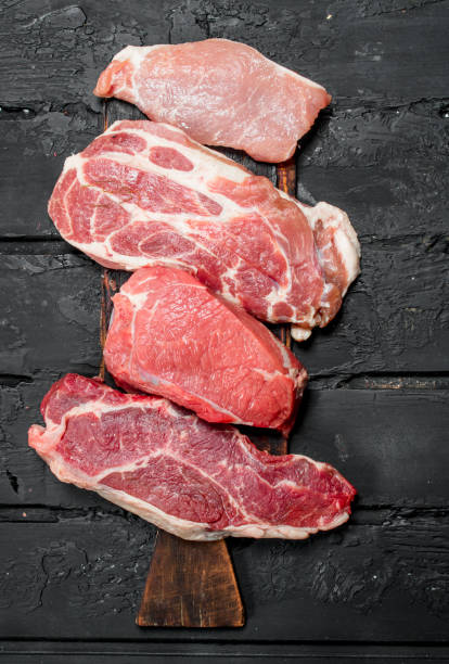 istock Raw meat pork and beef steaks. 1141701292