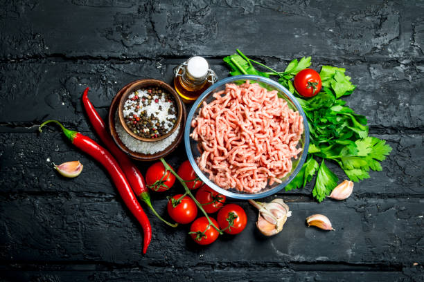 istock Raw minced meat in a bowl with vegetables and herbs. 1141702109