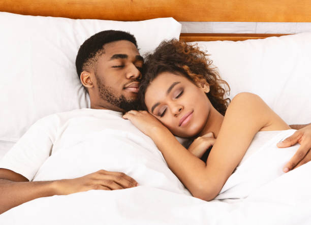 istock Loving couple sleeping in bed and hugging 1141702250