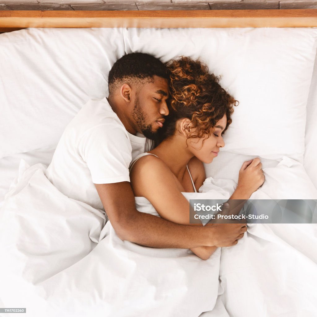 Loving Couple Sleeping In Bed And Hugging Stock Photo - Download ...