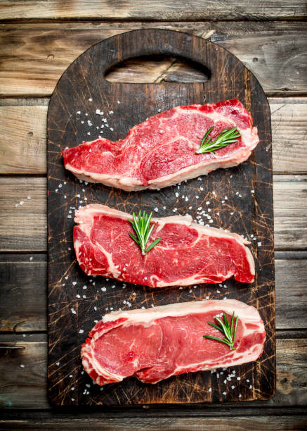 istock Raw marbled beef steaks with salt and aromatic spices. 1141702590