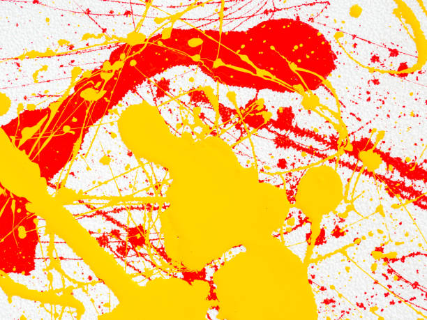 istock splashes of red and yellow paint on a white background 1141703475