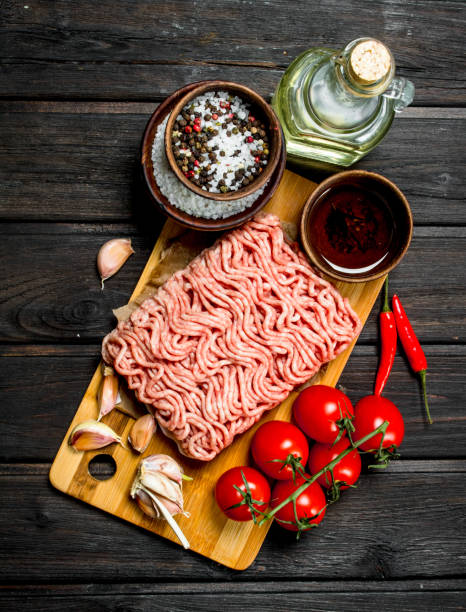 istock Raw ground beef with tomatoes and spices. 1141703629
