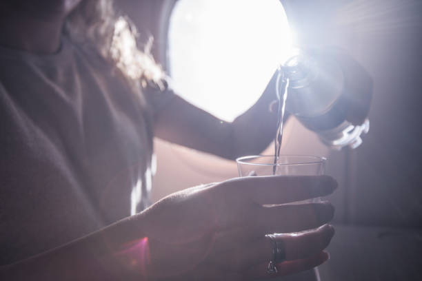 Pouring water in drinking glass.