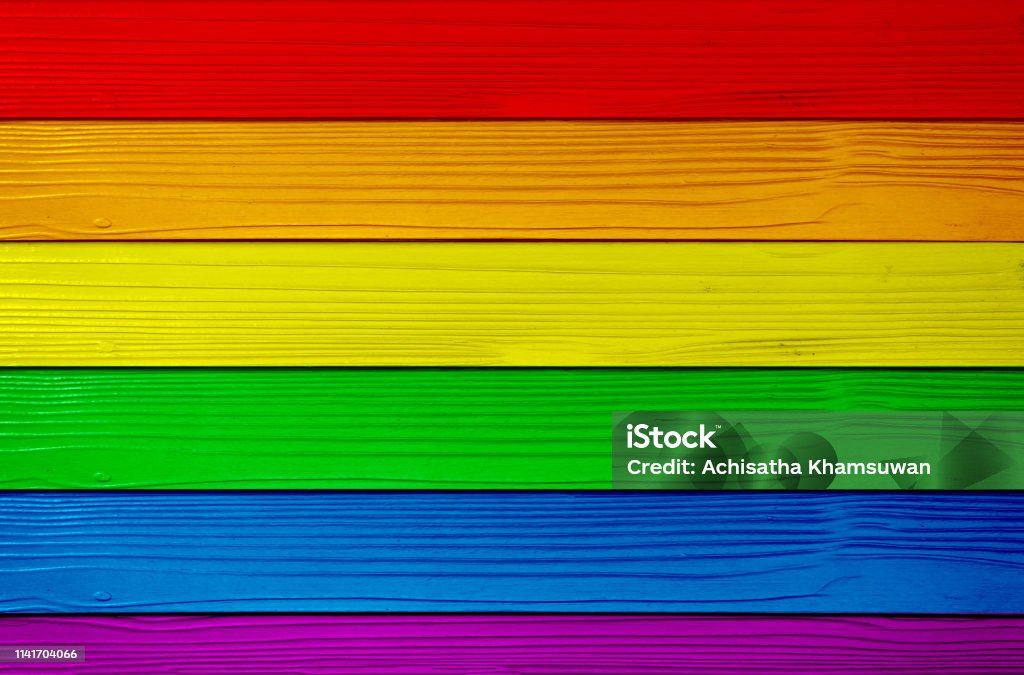 Symbol color of LGBTQ+ on wooden wall background. red orange yellow green blue purple. Symbol color of LGBTQ+ on wooden wall background. red orange yellow green blue purple. Concept of lgbtq community. Gay Person Stock Photo