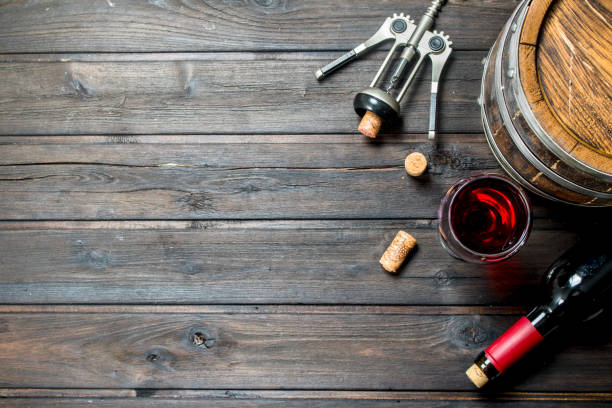 istock Wine background. A barrel of red wine with a corkscrew. 1141706510