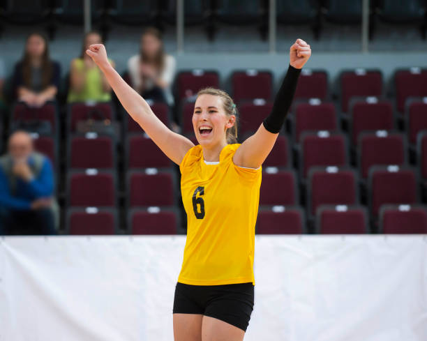 Volleyball player winning the cup. Team sport.