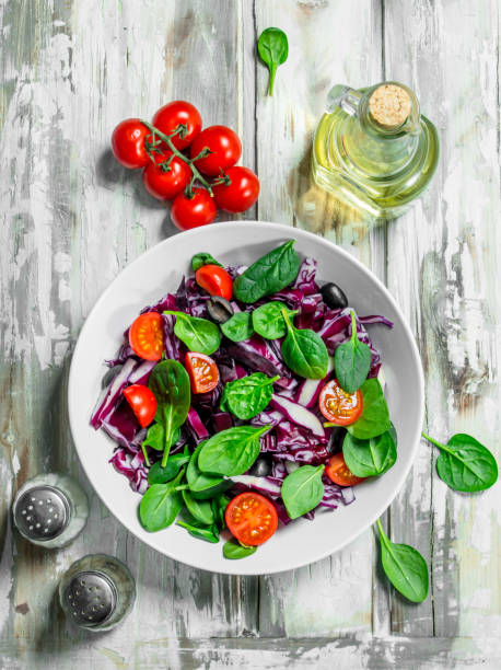 istock Vegetable salad. Red cabbage, tomato and spinach salad with olive oil. 1141708058