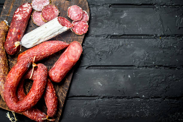 istock Different types of salami with spices and herbs. 1141708114