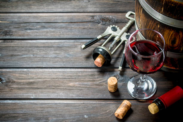 istock Wine background. A barrel of red wine with a corkscrew. 1141708539