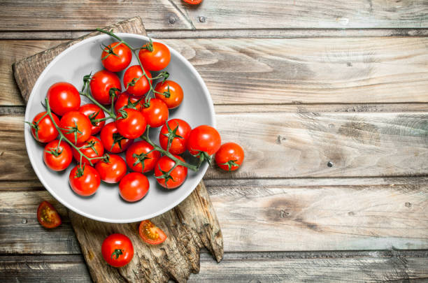 istock Tomatoes on a plate on a cutting Board. 1141709575