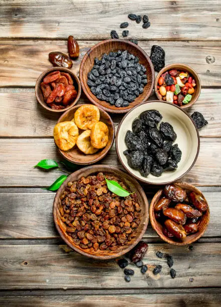 Photo of Assortment of different dried fruits in bowls.