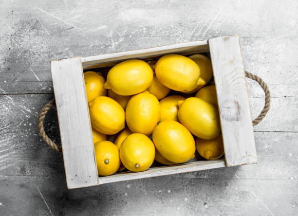 istock Fresh yellow lemons in wooden box. 1141711053