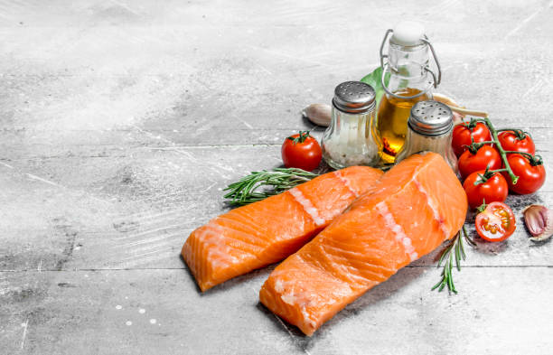 istock Raw salmon steaks with spices, herbs and olive oil. 1141711090