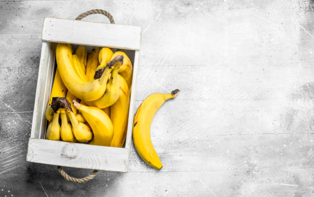 Fresh bananas in a wooden box.