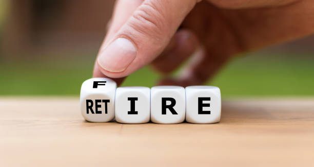istock Retire or get fired. Hand turns a dice and changes the word 